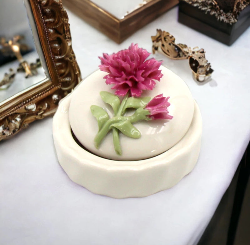 Ceramic jewelry box with pink carnation flower on round hinged lid