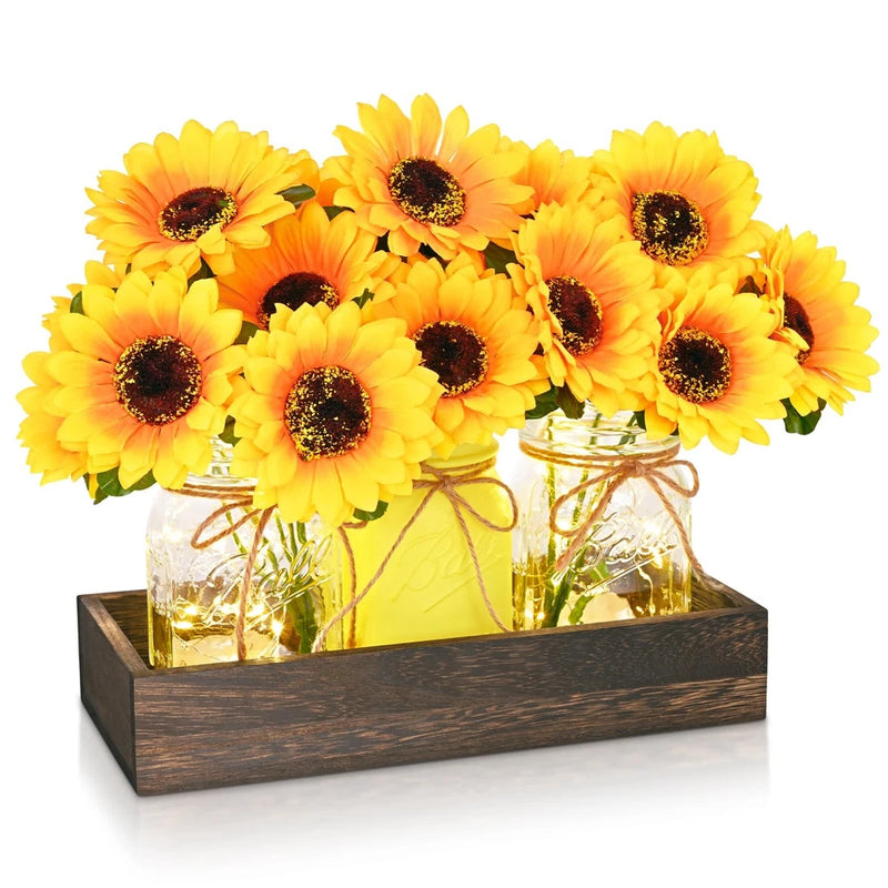 Wood tray centerpiece with three artificial sunflowers in clear mason jars with warm lights