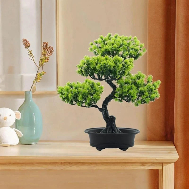 Artificial bonsai tree with bright green foliage in a black round planter