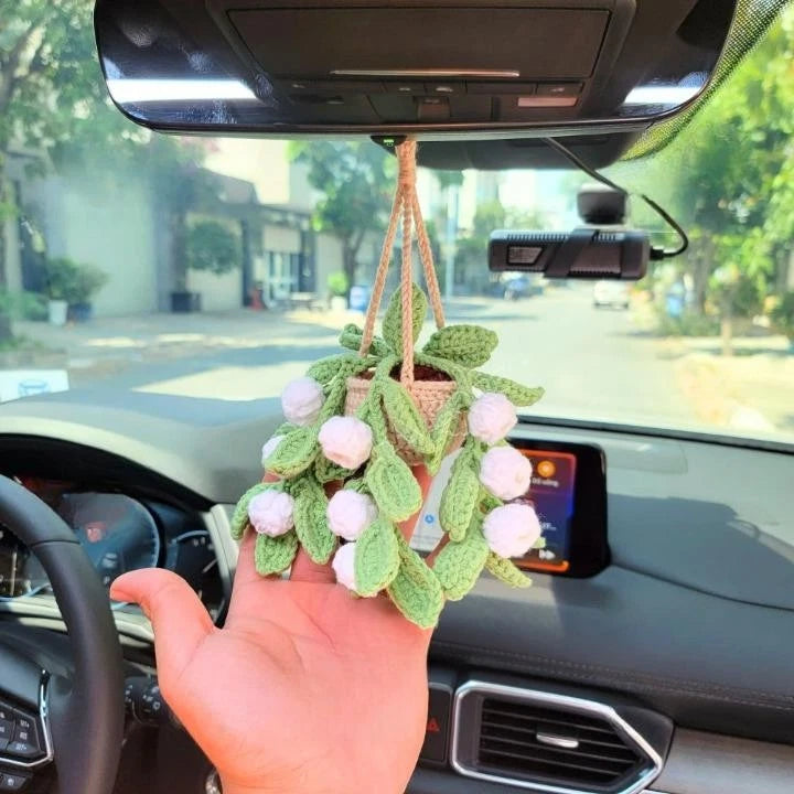 Crochet lily of the valley hanging plant with pink blossoms and leaf detailing
