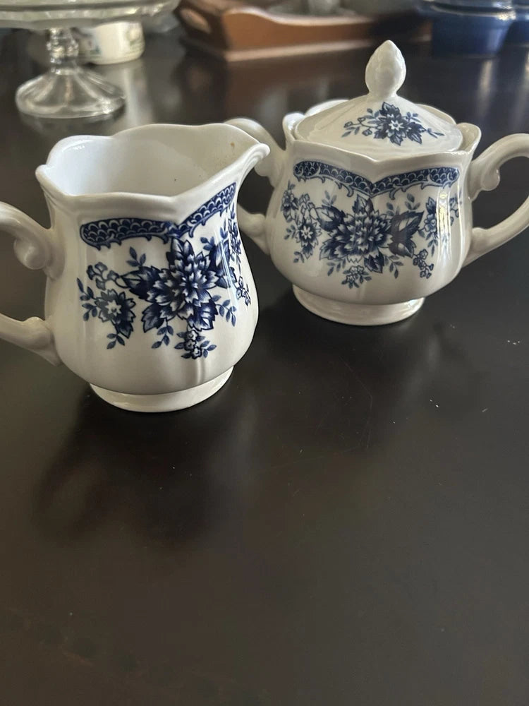 Porcelain cream and sugar set, blue floral design with creamer and lidded sugar bowl