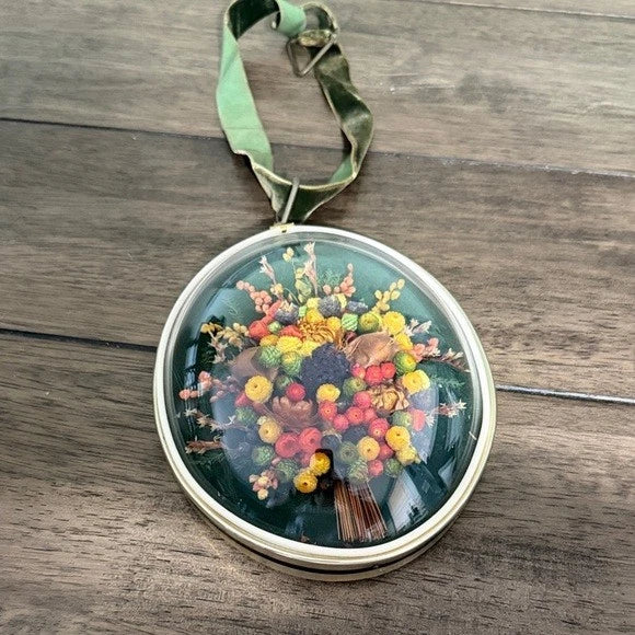 Round dried flower wall hanging globe with multicolor blossoms in glass