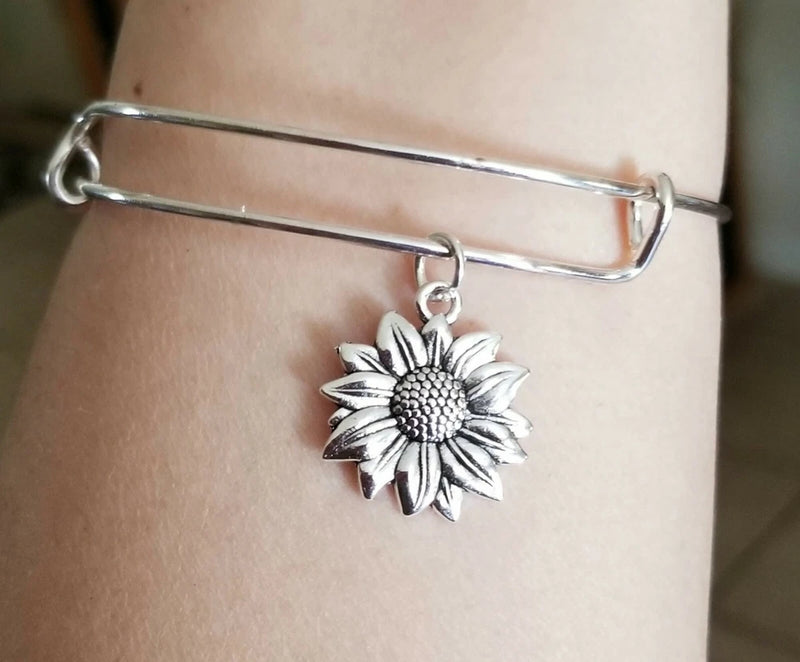Silver sunflower charm bracelet with hinged clasp and detailed flower pendant