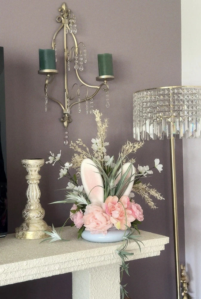 Pink peony and greenery floral arrangement with curved stems in modern vase