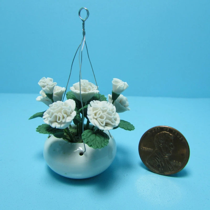 Miniature hanging white carnation flower arrangement in blue pot with hanging loop
