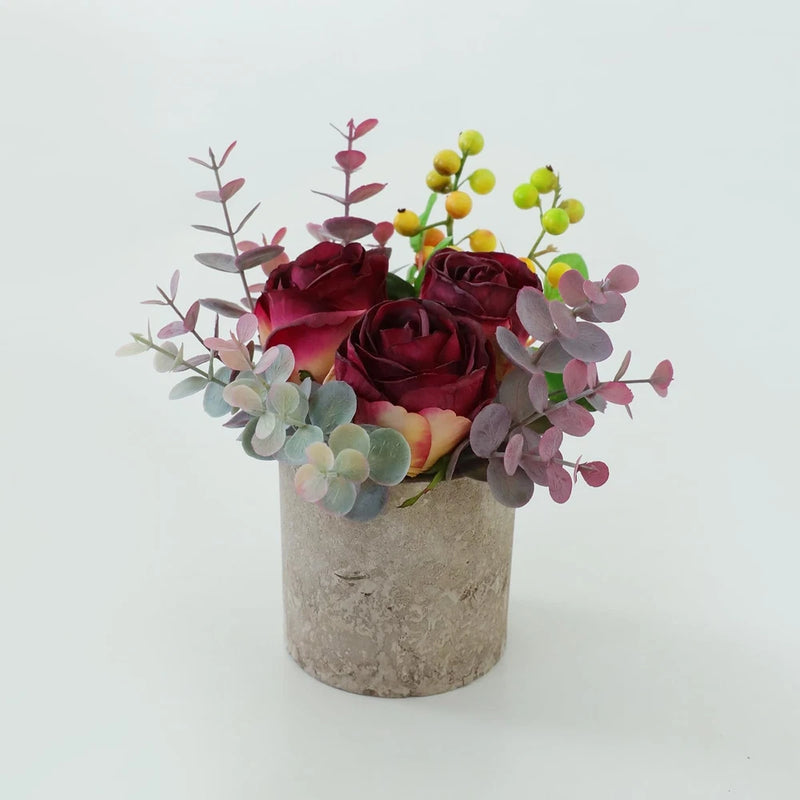 Artificial rose bouquet in concrete-style pot: burnt burgundy roses with green, pink, yellow accents