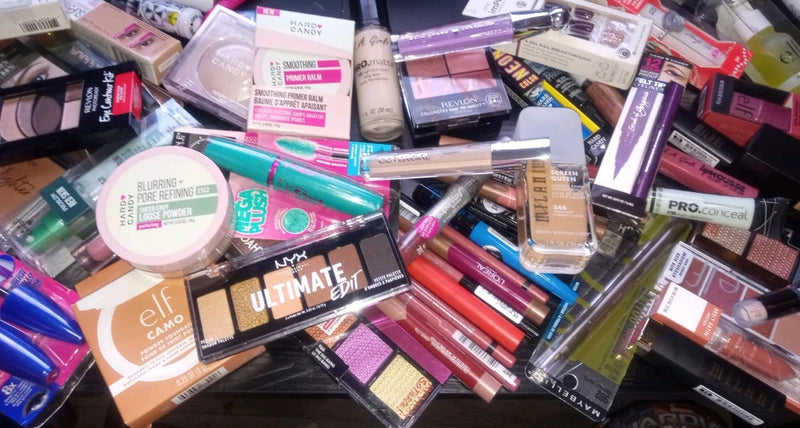 Assorted makeup product set with lipsticks, foundations, and eye/face palettes.