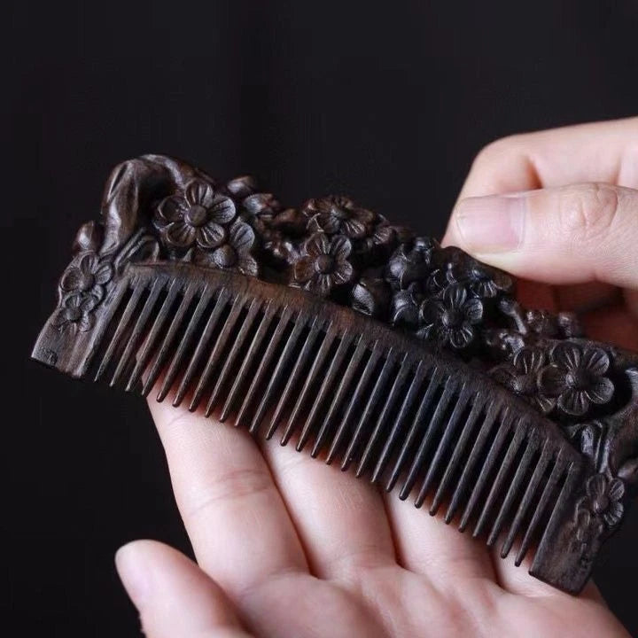 Hand-carved dark brown wood comb with peony blossom flower engravings