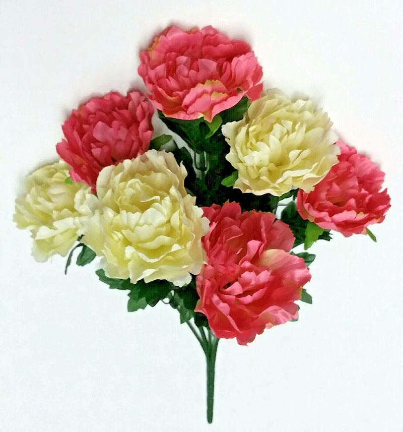 Silk peony flower bush with pink, cream, and red blooms and green leaves