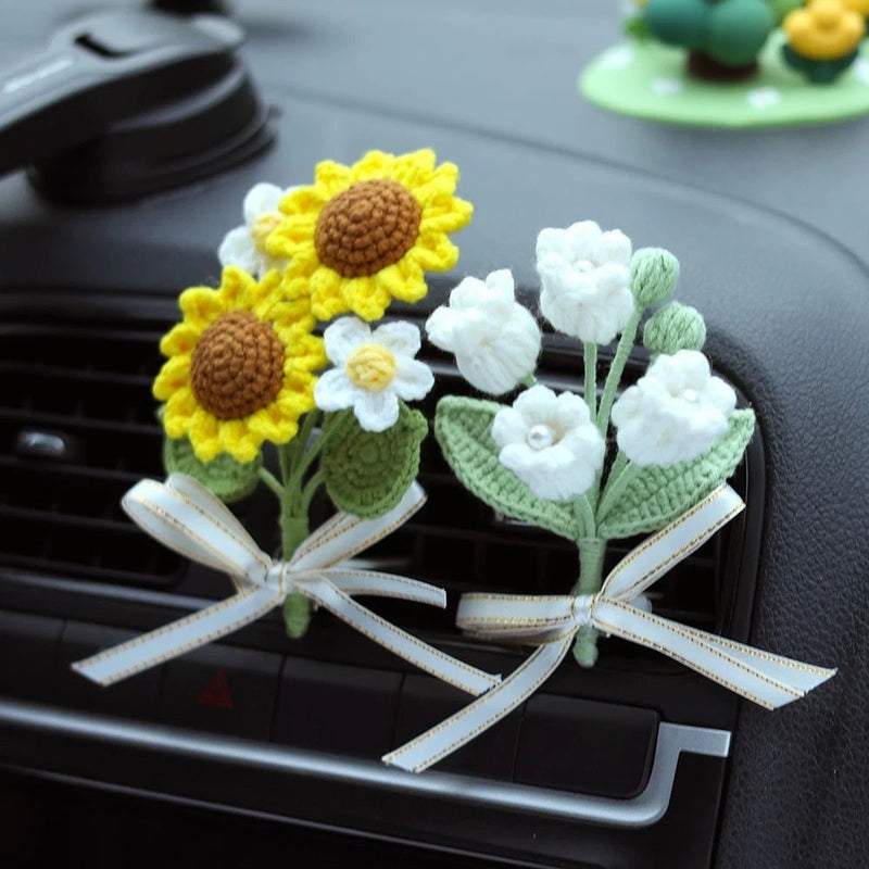 Crochet sunflower air-vent decor with yellow and white flowers, green leaves, and bow ribbons