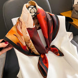 Silk square scarf with peony-style florals in cream, orange, red, and brown