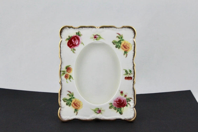 Bone china photo frame with colorful rose floral border and oval opening