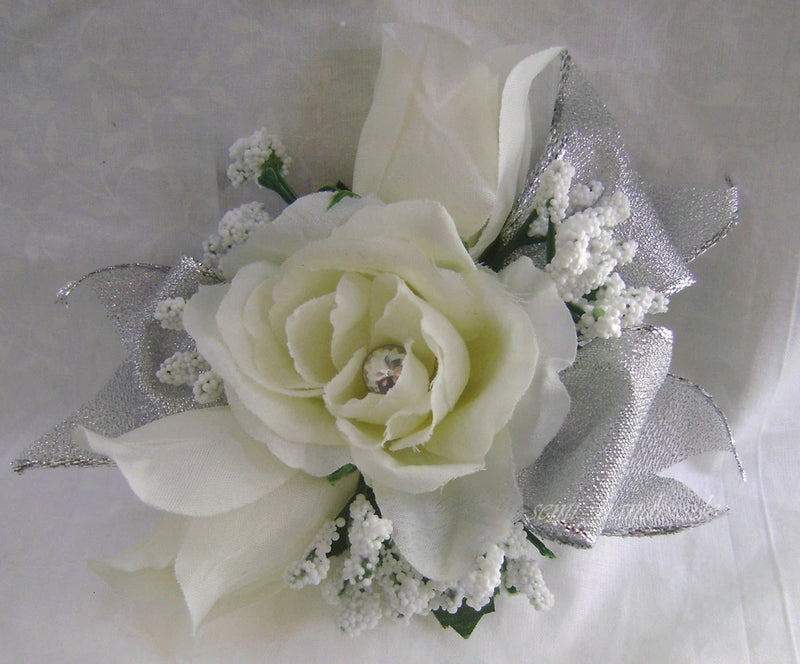 Ivory rose corsage wristlet with baby’s breath and silver ribbon accents
