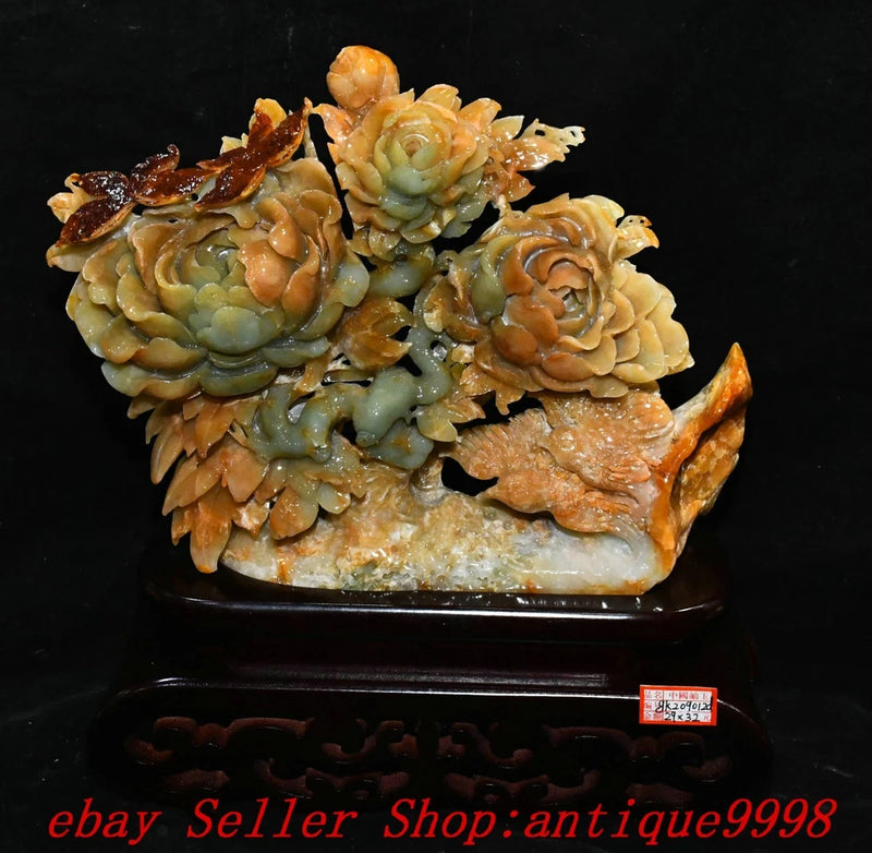 Carved jade peony flower and bird statue with floral details on dark base