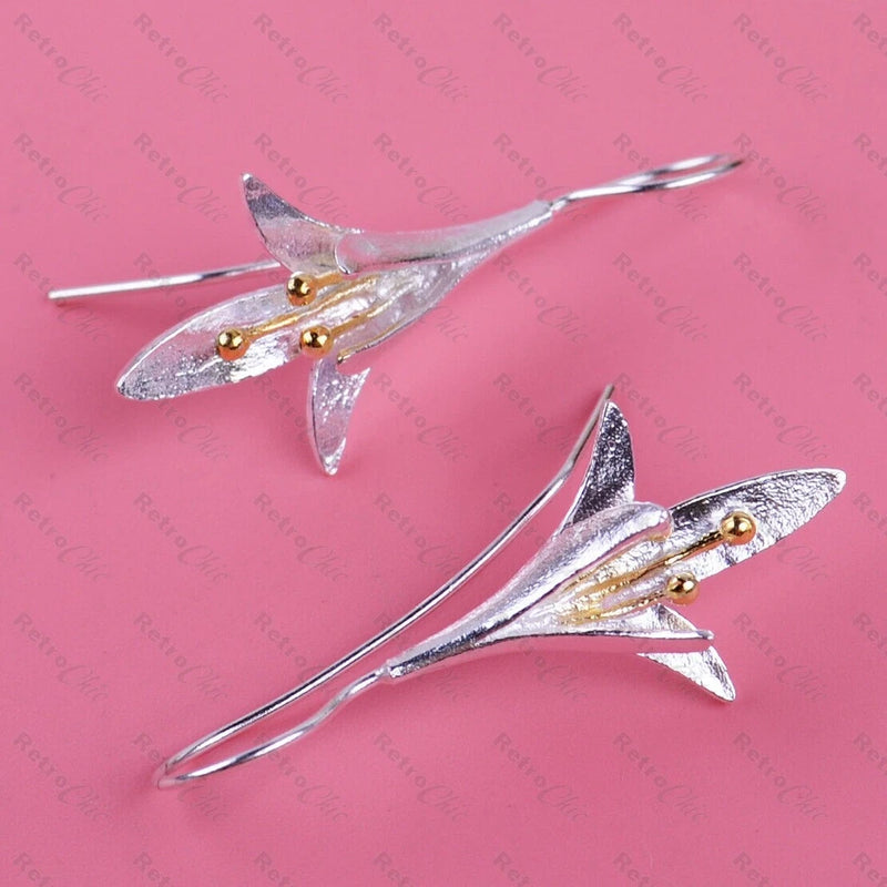 Silver-tone lily of the valley dangle earrings with long hook stems and floral charms