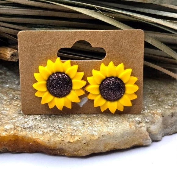 Sunflower stud earrings with yellow petals and dark center, pierced flower design