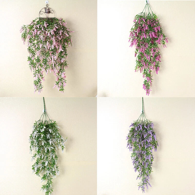 Hanging artificial flower wall decoration with layered green, purple and pink blooms