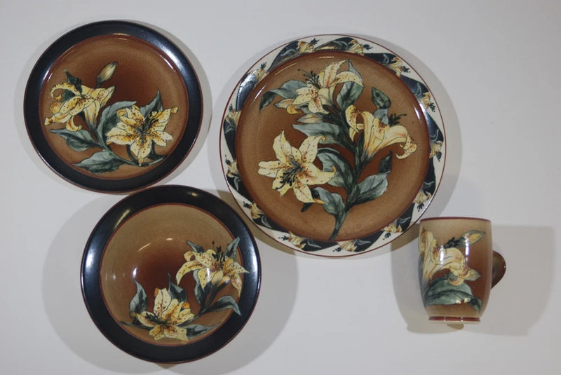 4-piece dinner place setting with brown round plates and gold lily floral accents