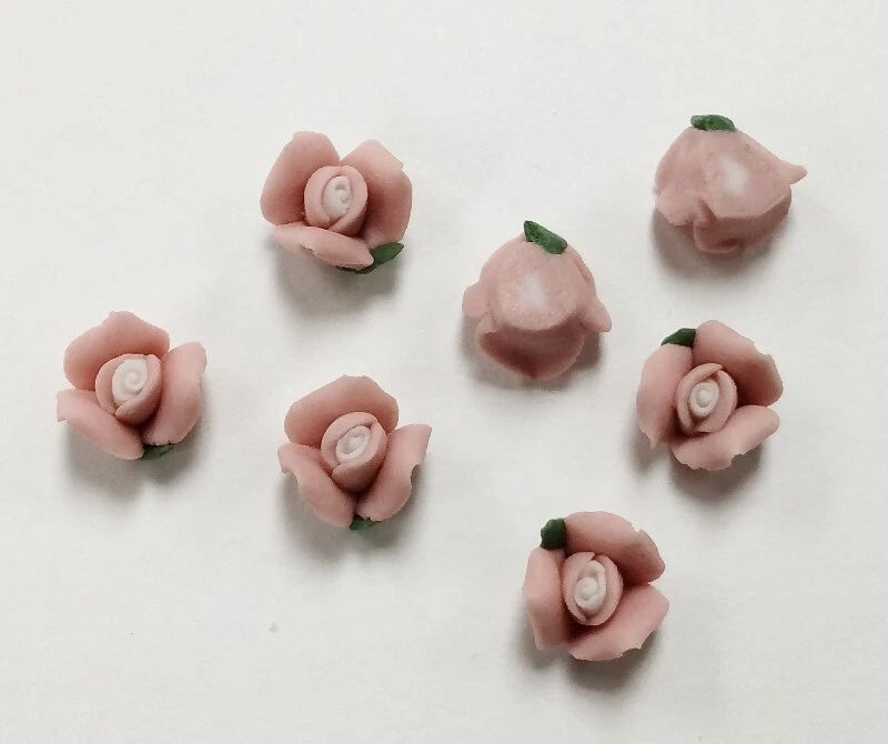 Dusty pink porcelain rose cabochons with white spiral centers and green leaf backs