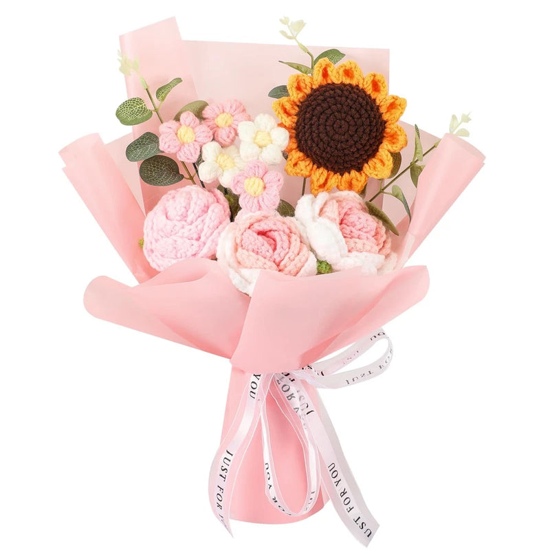 Crochet flower bouquet with sunflower, pink and cream blossoms, green leaves, wrapped in pink paper