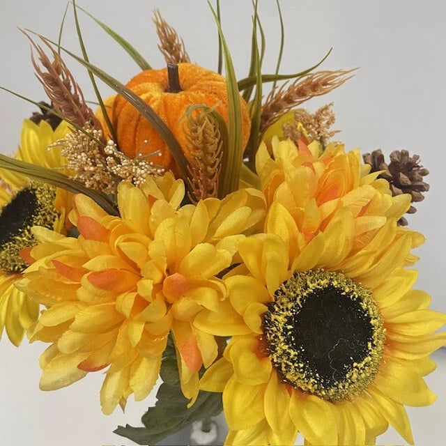 Artificial sunflower floral bush with yellow blooms and dark centers, orange accents and green stems.