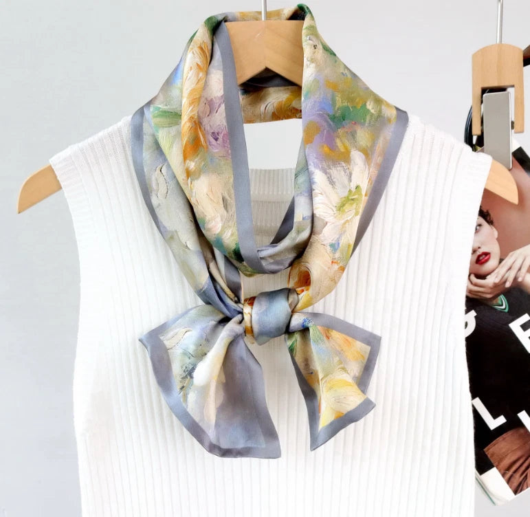 Silk square scarf with peony flower print, light blue border, tied bow at neckline