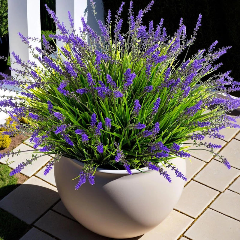Artificial faux monkey grass with purple flower spikes in white planter