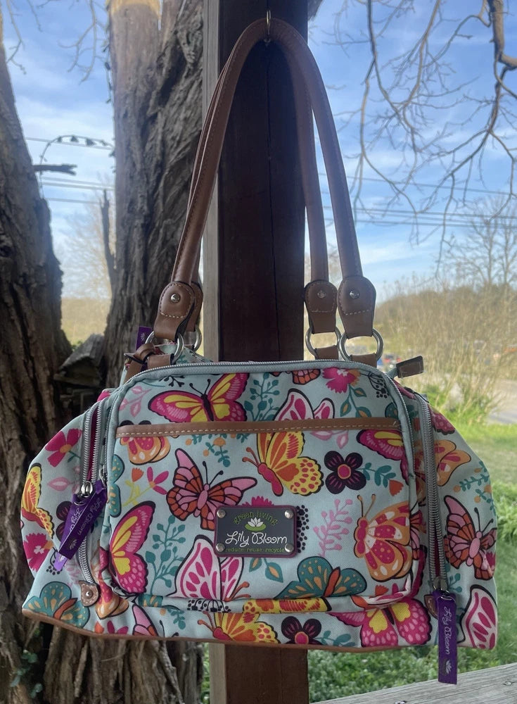 Lily bloom satchel handbag in light teal with colorful butterfly print, front zipper pocket