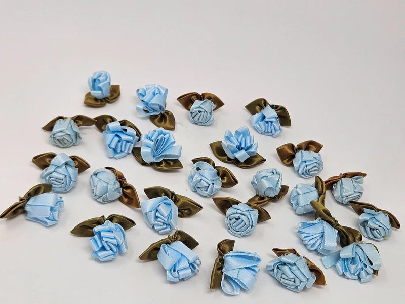 Set of 25 blue satin ribbon rose applique flowers with brown leaf accents.
