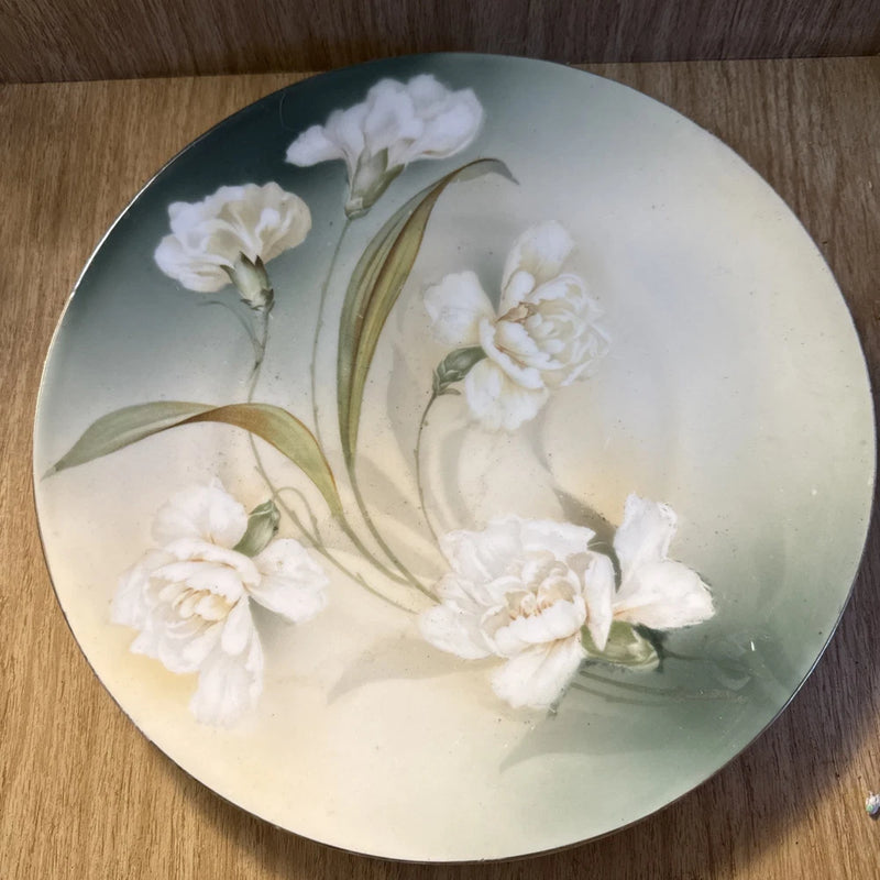 Antique handpainted porcelain plate with white carnation flowers and green leaves