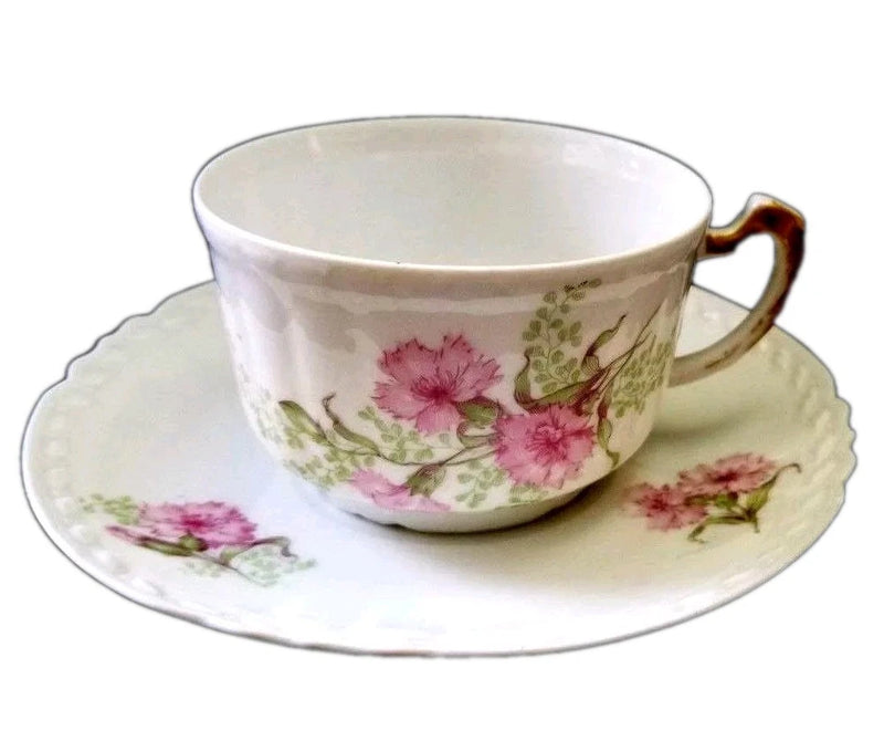 Antique porcelain teacup and saucer set with pink floral carnation pattern, gold handle
