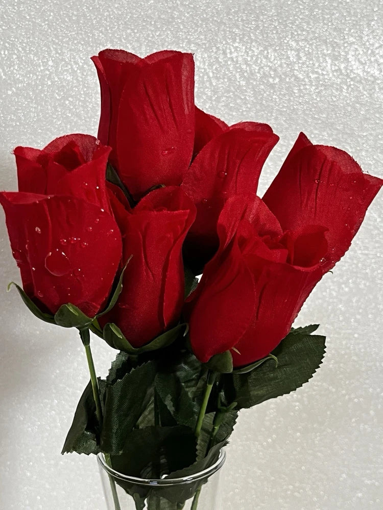 Artificial red rose bud bouquet in vase with raindrop details