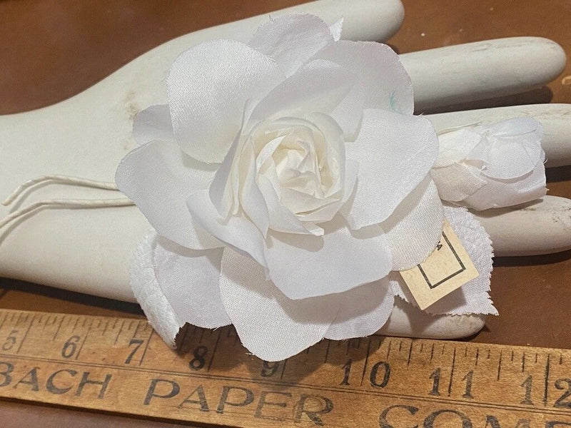 White silk rose floral pin with layered petals and leaf details