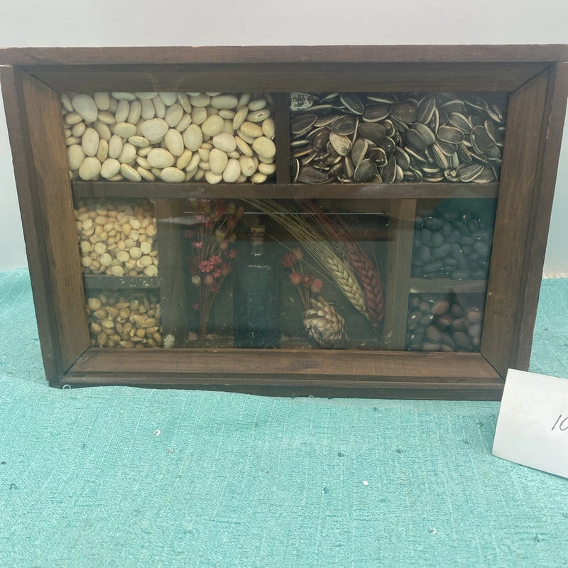 Wood shadowbox wall hanging with dried flowers and leaf-filled compartments