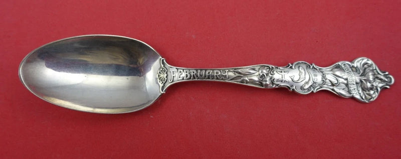 Silver decorative teaspoon with ornate floral handle detail