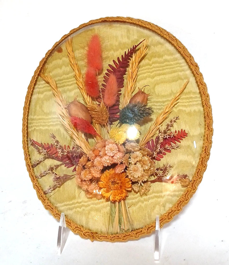 Vintage oval framed dried flower bouquet under convex bubble glass