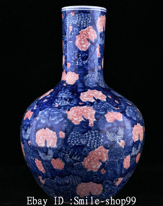 Blue porcelain bottle vase with pink peony and white accents, wide belly and narrow neck