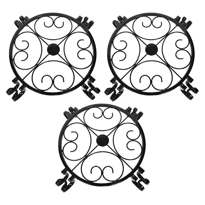 Black wrought iron circular flower rack set with scrollwork and three swirl panels