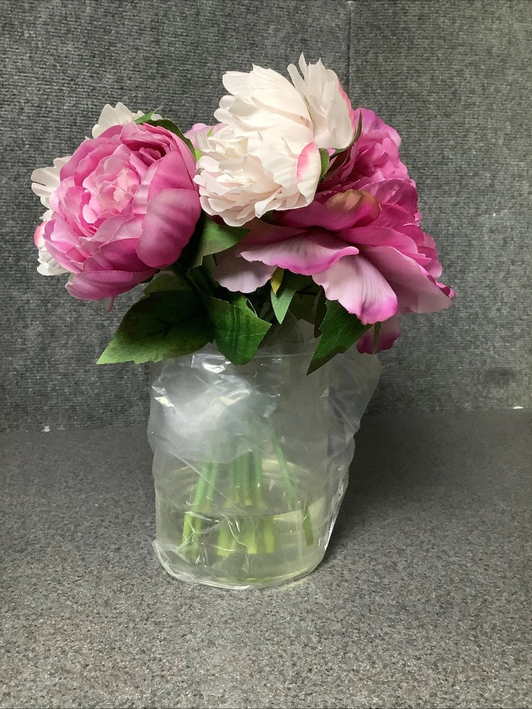 Artificial peony arrangement with fuchsia and white faux flowers in clear glass vase
