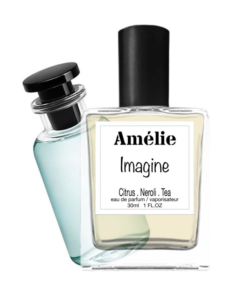 Amélie Imagine EDP with two fragrance bottles, one square and one tilted clear blue