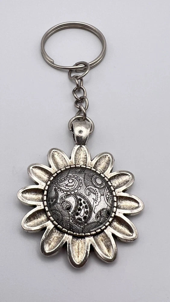 Silver sunflower keychain with circular engraved medallion and metal key ring