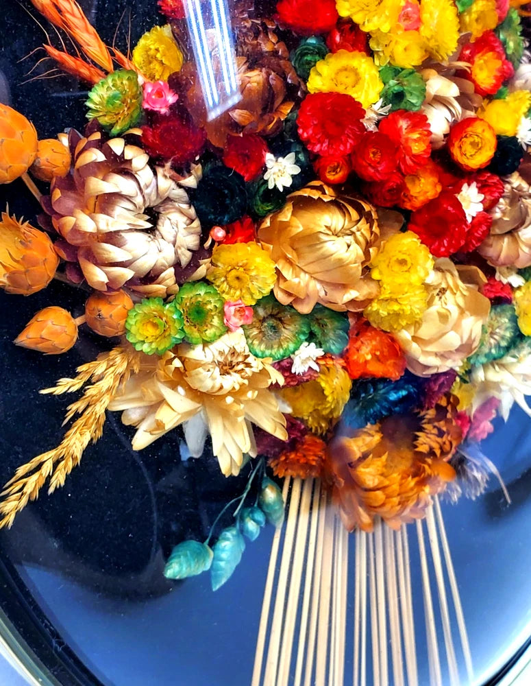 Oval convex glass wall frame with colorful dried straw flower arrangement