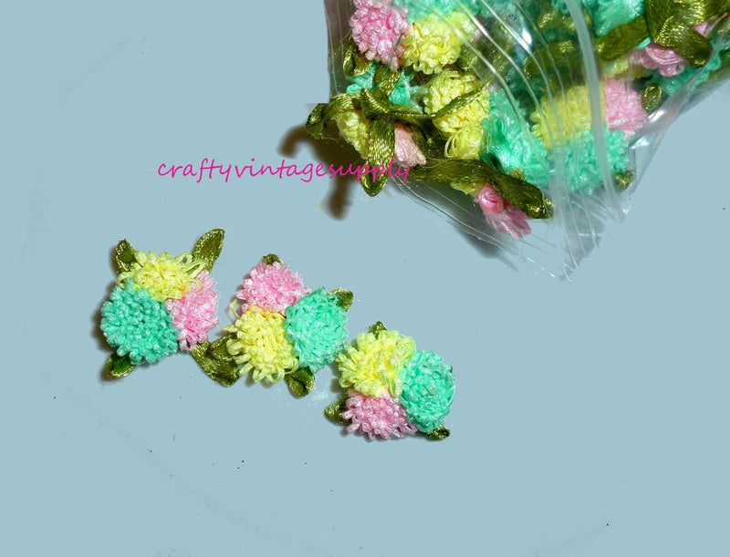 Multicolor ribbon carnation flower appliques with leaves and pink, teal, yellow blooms