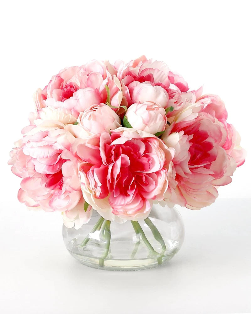 Artificial pink and red peony bouquet in clear glass vase, faux silk flowers