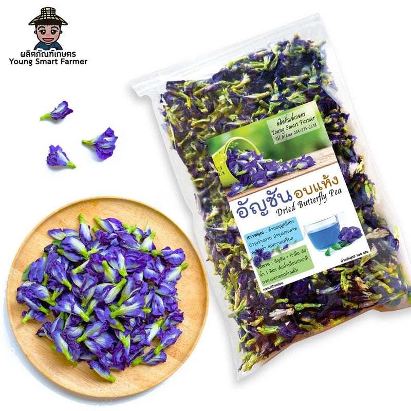Bag of dried butterfly pea flowers with purple petals in wooden bowl
