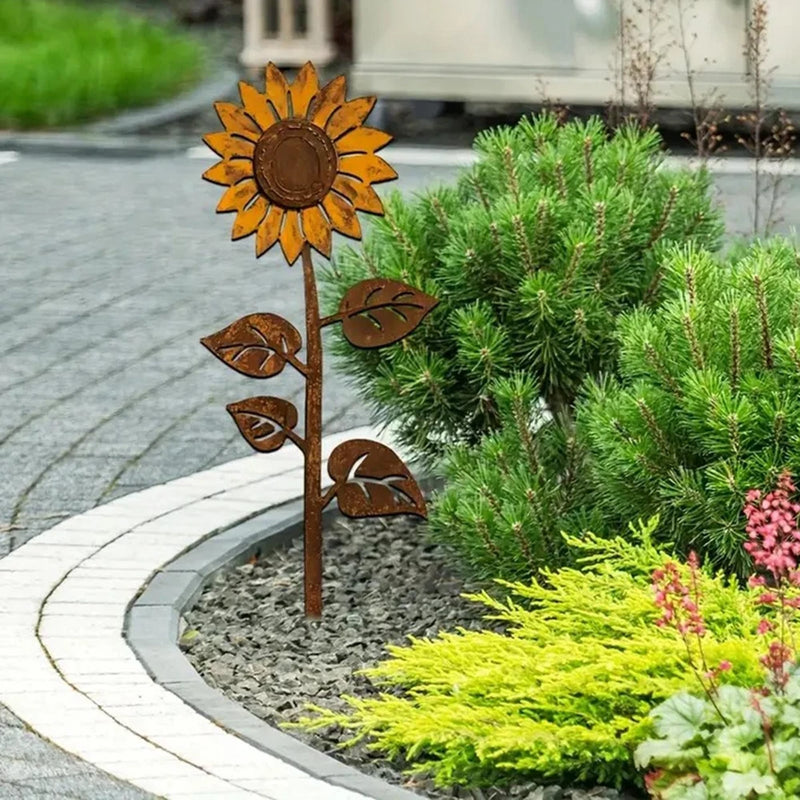 Rust-brown sunflower garden stake ornament with spoked center and leaf accents.