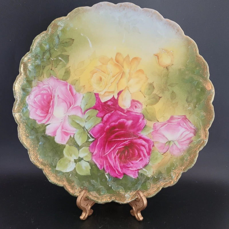 Decorative porcelain plate with pink and green carnation floral design, scalloped rim