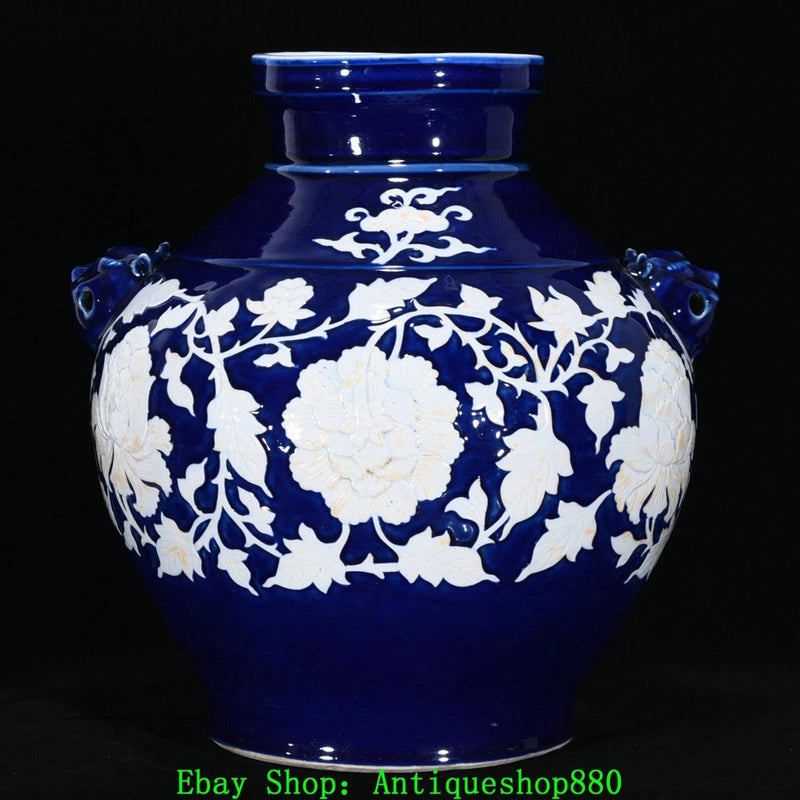 Blue glaze porcelain jar with white peony-and-vine design, beast-head handles