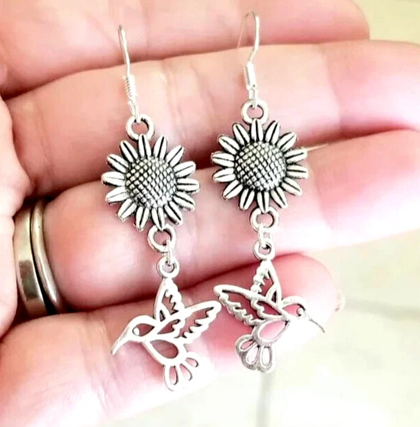 Silver sunflower and hummingbird dangle earrings, dangling birds and floral charms.