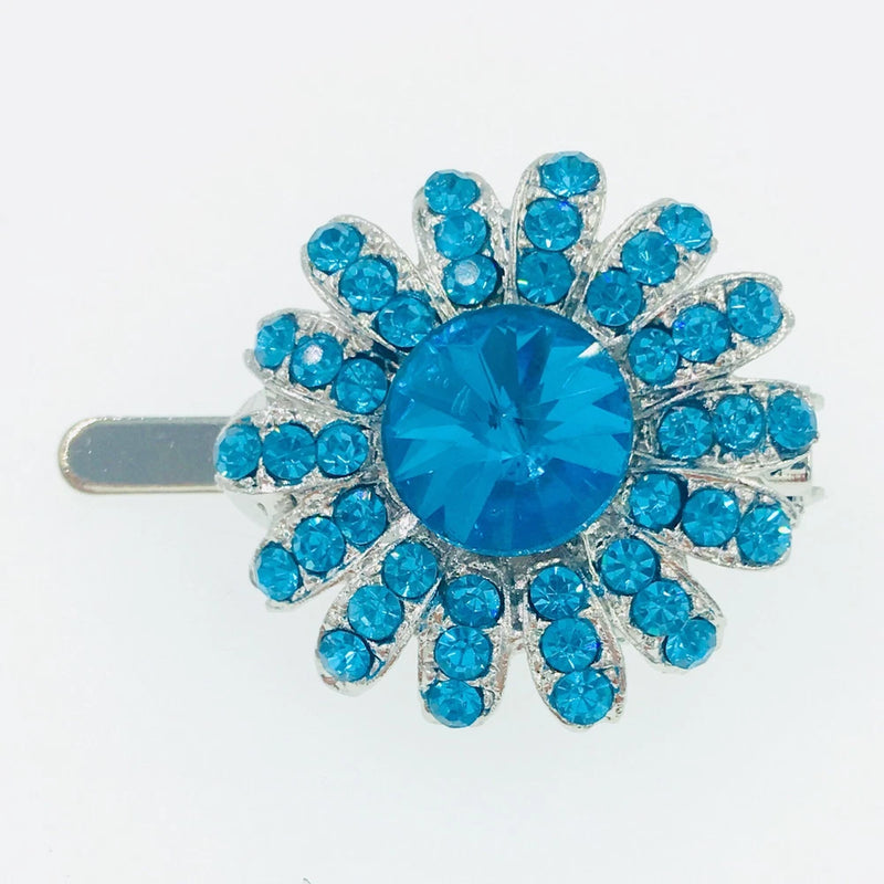 Blue rhinestone flower hair clip with crystal center and silver-tone barrette pin